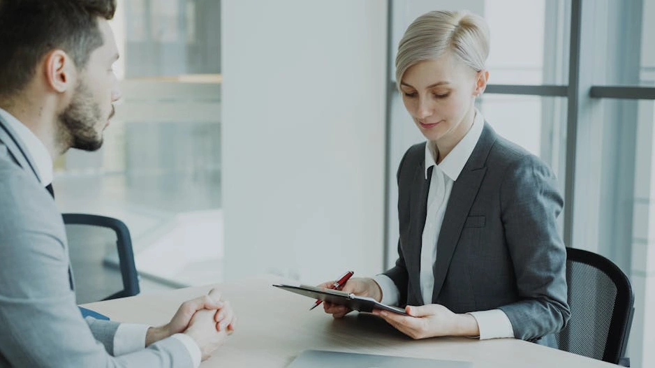 A diverse group of executives collaborating in a modern, sunlit office.